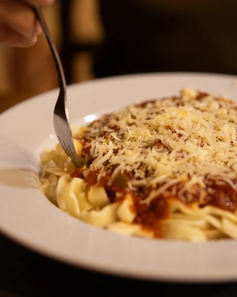 Tallarines al huevo con tuco y queso rallado